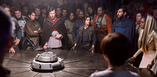 Rogue One: A Star Wars Story (2016) Felicity Jones (C) and Riz Ahmed (behind) - briefing room, with Felicity and the Senator Jebel (guy in red and grey), Senator Vaspar (guy in blue), Senator Pamlo (lady in gold). Also back of Mon Mothma's head